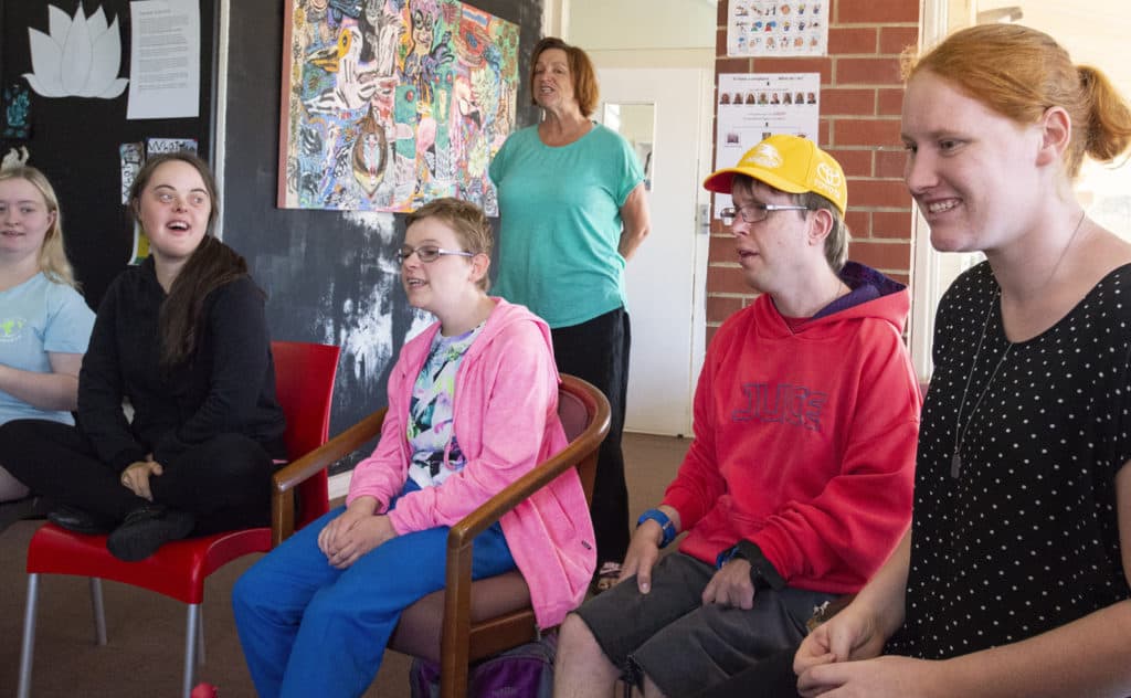 Supportive NDIS group therapy session for individuals with disabilities at Assured Care Solutions, focusing on mental health and community integration.