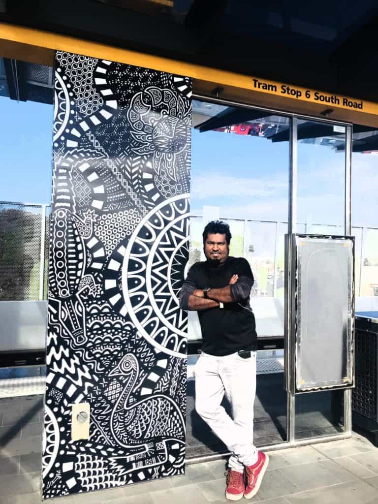 Aboriginal-inspired mural at tram stop with cultural symbols, highlighting NDIS community engagement, diversity, and inclusion.